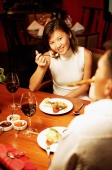 Couple eating at restaurant, over the shoulder view - Alex Microstock02