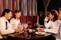 Couples sitting at restaurant, having dinner - Alex Microstock02