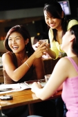 Young women at cafe, smiling - Alex Microstock02
