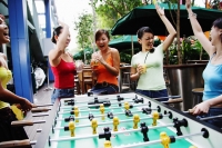 Young women celebrating winning a game of foosball - Alex Microstock02