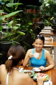 Young women at cafe, eating and drinking - Alex Microstock02