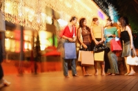 Young women standing side by side, carrying shopping bags - Alex Microstock02