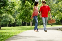 Couple walking in park, looking at each other - Alex Microstock02