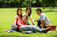 Young adults sitting in park, looking at camera - Alex Microstock02
