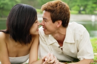 Couple lying on grass, face to face, noses touching - Alex Microstock02