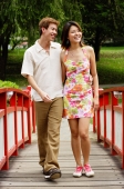 Couple walking over bridge in park - Alex Microstock02