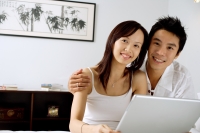 Couple with laptop, smiling at camera - Alex Microstock02