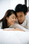 Couple lying in bed, side by side, cheek to cheek - Alex Microstock02