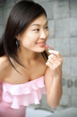 Woman applying lipstick - Alex Microstock02