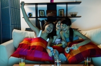 Young women in living room, playing video games - Alex Microstock02