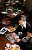 Businesswomen at cafe, using laptop - Alex Mares-Manton