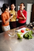 Women in kitchen, standing side by side, holding drinks - Alex Microstock02