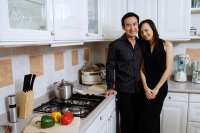 Couple in kitchen, smiling at camera - Alex Microstock02