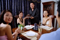 Friends at home, man and woman holding cake, looking at camera - Alex Microstock02