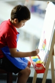 Boy sitting in front of easel, painting - Alex Microstock02