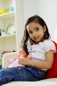 Young girl playing with doll, smiling - Alex Microstock02
