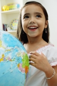 Young girl standing in front of globe, looking away - Alex Microstock02