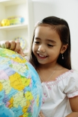 Young girl pointing at a globe - Alex Microstock02