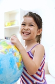 Young girl touching globe, smiling - Alex Microstock02