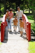 Family with three boys walking across bridge - Alex Microstock02