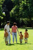 Family with three boys walking in park - Alex Microstock02