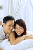 Couple lying on bed, looking at camera - Alex Microstock02