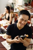 Man looking at camera, holding wine bottle - Alex Microstock02