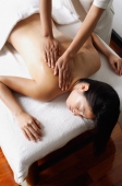 Woman lying on massage table being massaged - Alex Microstock02