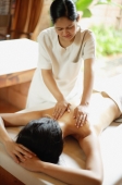 Woman on massage table receiving back massage - Alex Mares-Manton