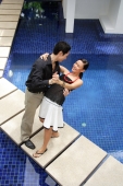 Couple dancing by swimming pool, man dipping woman - Alex Mares-Manton