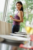 Woman with wine glass turning to look at camera - Alex Mares-Manton