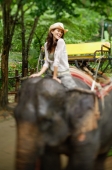Young woman on elephant, smiling at camera, Phuket, Thailand - Alex Mares-Manton