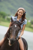 Woman sitting on horse, smiling - Alex Mares-Manton