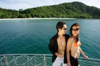 Couple on boat deck, standing next to railing - Alex Mares-Manton
