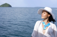 Woman wearing white hat, ocean behind her - Alex Mares-Manton