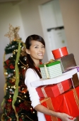 Woman standing, carrying a pile of gifts - Alex Microstock02