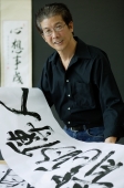 Man holding rice paper with Chinese calligraphy - Alex Microstock02