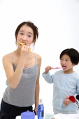 Mother and young daughter brushing teeth - blueduck