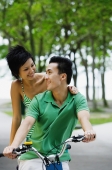 Couple on tandem bicycle, looking at each other - Alex Microstock02