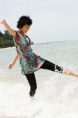 Woman on beach, kicking water - Alex Microstock02