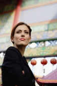 Businesswoman looking away, temple gates in the background - Alex Microstock02