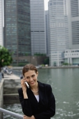Businesswoman using mobile phone, river and buildings in the background - Alex Microstock02