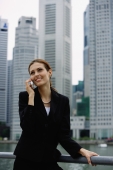 Businesswoman on mobile phone, river and buildings in the background - Alex Microstock02