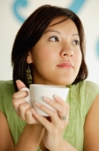 Woman holding cup, looking away - Alex Microstock02