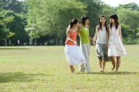 Young women in park, walking side by side - Wang Leng