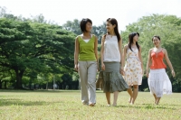 Four young women walking across field - Wang Leng