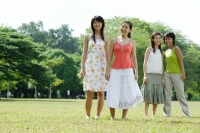 Young women standing side by side in field - Wang Leng