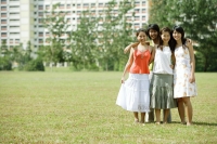 Young women standing together, smiling at camera - Wang Leng