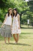 Two young women standing side by side, looking at camera - Wang Leng