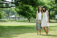 Two young women standing side by side, smiling at camera - Wang Leng